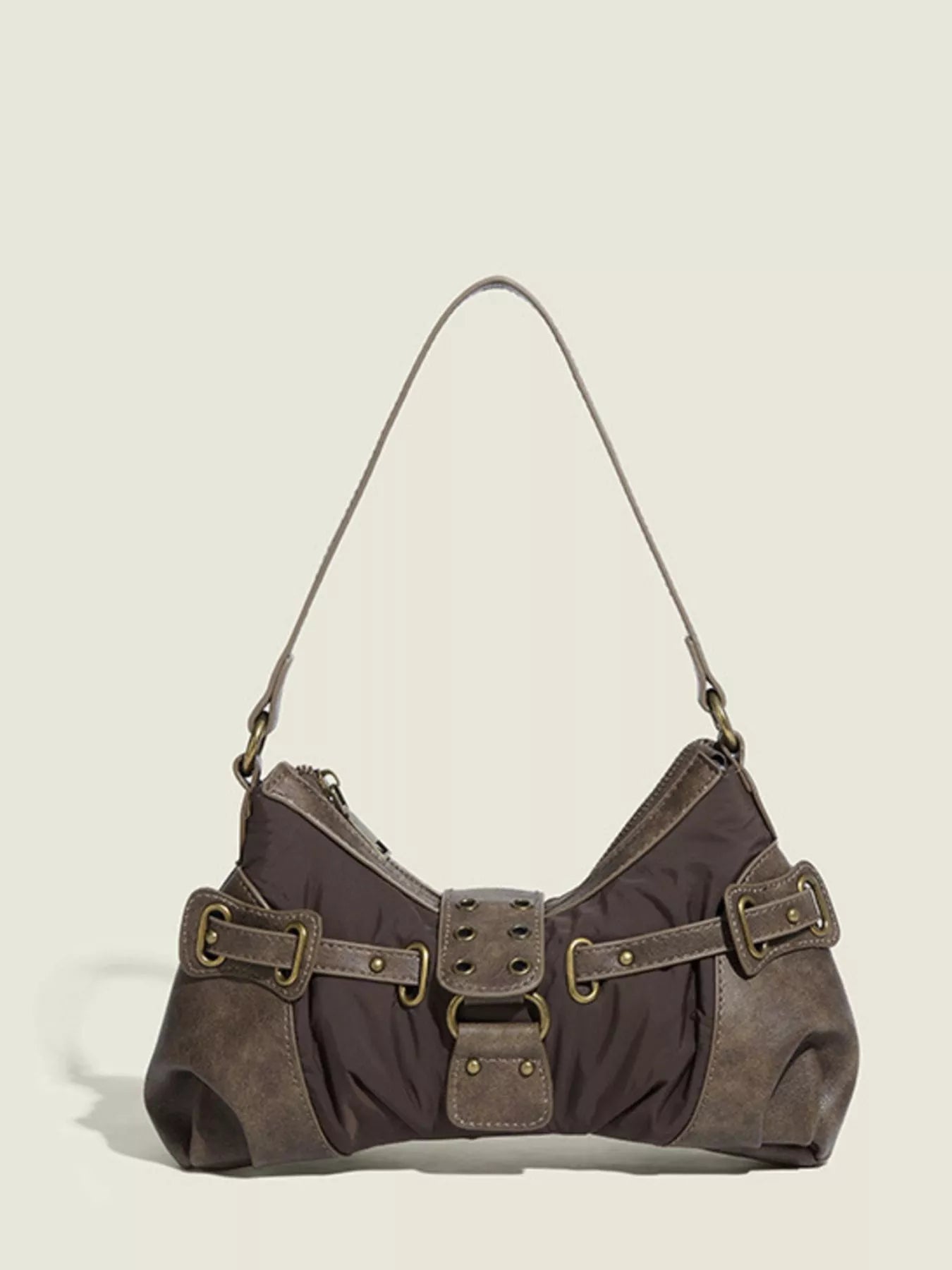 Brown handbag with gold buckles on a beige background