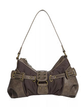 Brown leather handbag with gold buckles on a white background