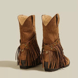 Brown suede Western boots with pointed toes, layered fringe, studded straps and low heels.