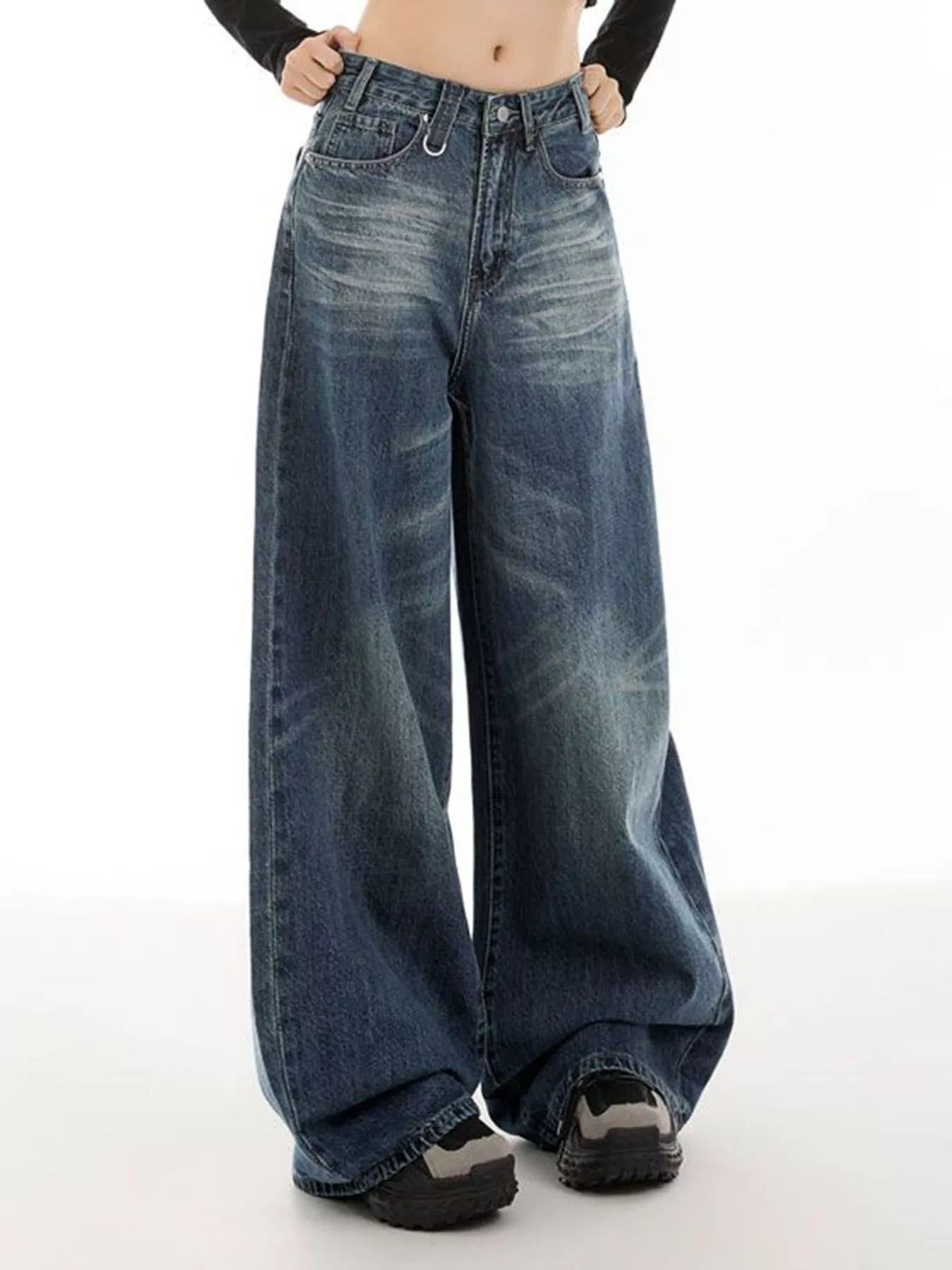 Woman wearing vintage wash high-rise wide leg blue jeans with a relaxed fit and classic five-pocket styling.