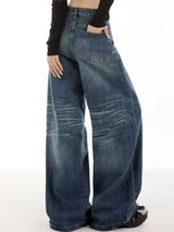 Woman wearing vintage wash high-rise wide leg blue jeans with a relaxed fit and classic five-pocket styling.