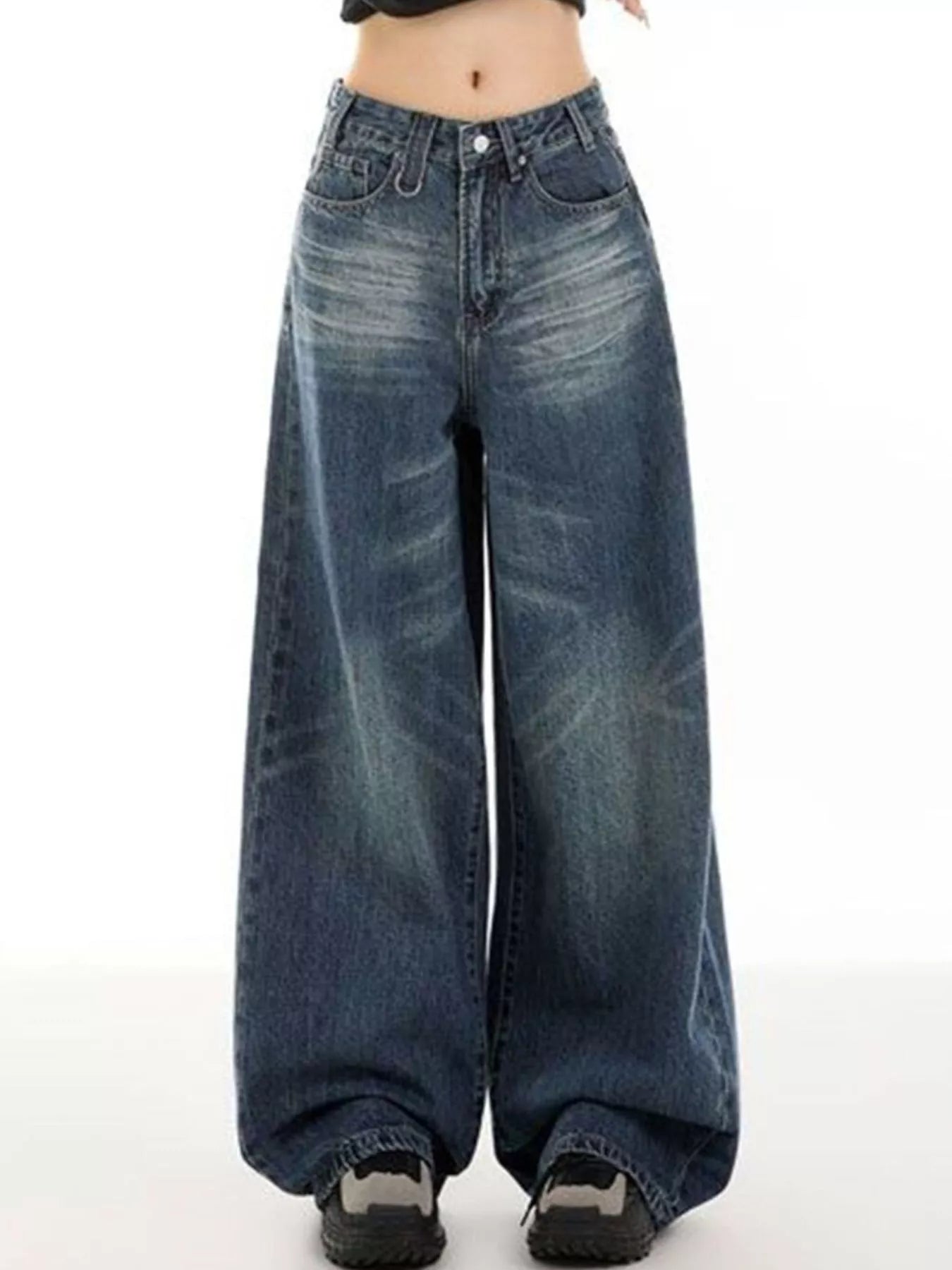 Woman wearing vintage wash high-rise wide leg blue jeans with a relaxed fit and classic five-pocket styling.
