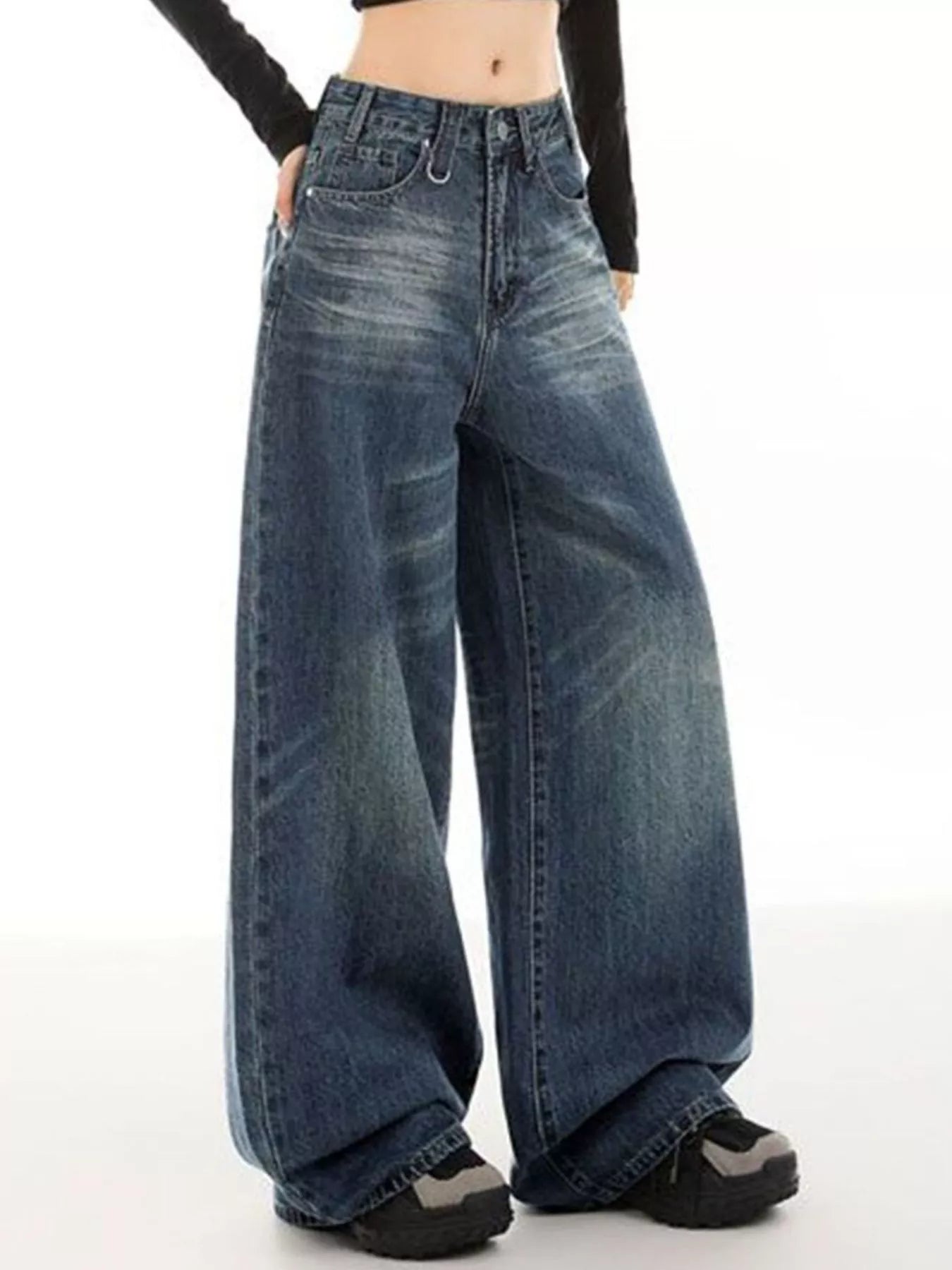 Woman wearing vintage wash high-rise wide leg blue jeans with a relaxed fit and classic five-pocket styling.