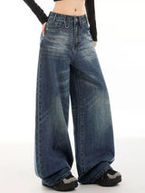 Woman wearing vintage wash high-rise wide leg blue jeans with a relaxed fit and classic five-pocket styling.
