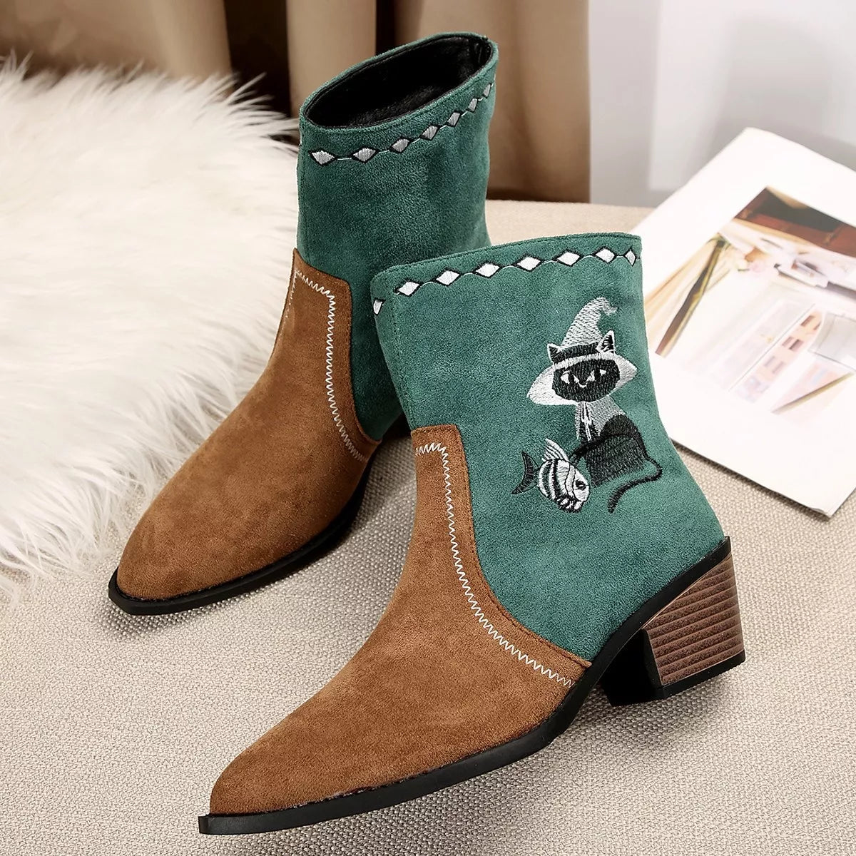 Women's green Western cowboy boots with classic embroidered detailing and comfortable mid heel.