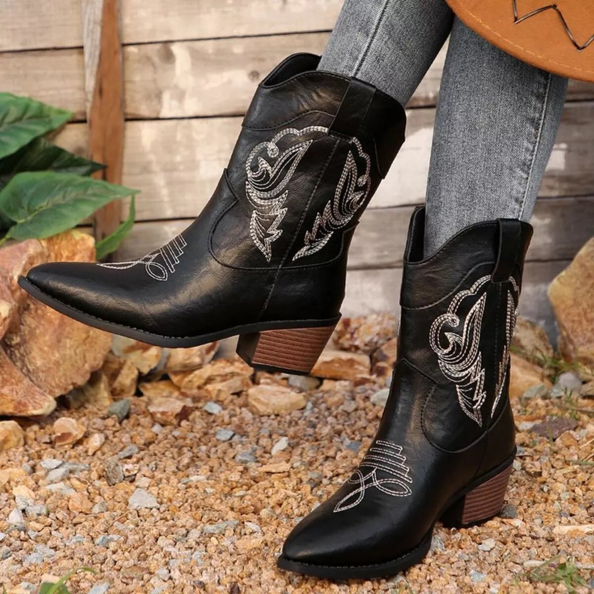 Women's black Western cowboy boots with classic embroidered detailing and comfortable mid heel.
