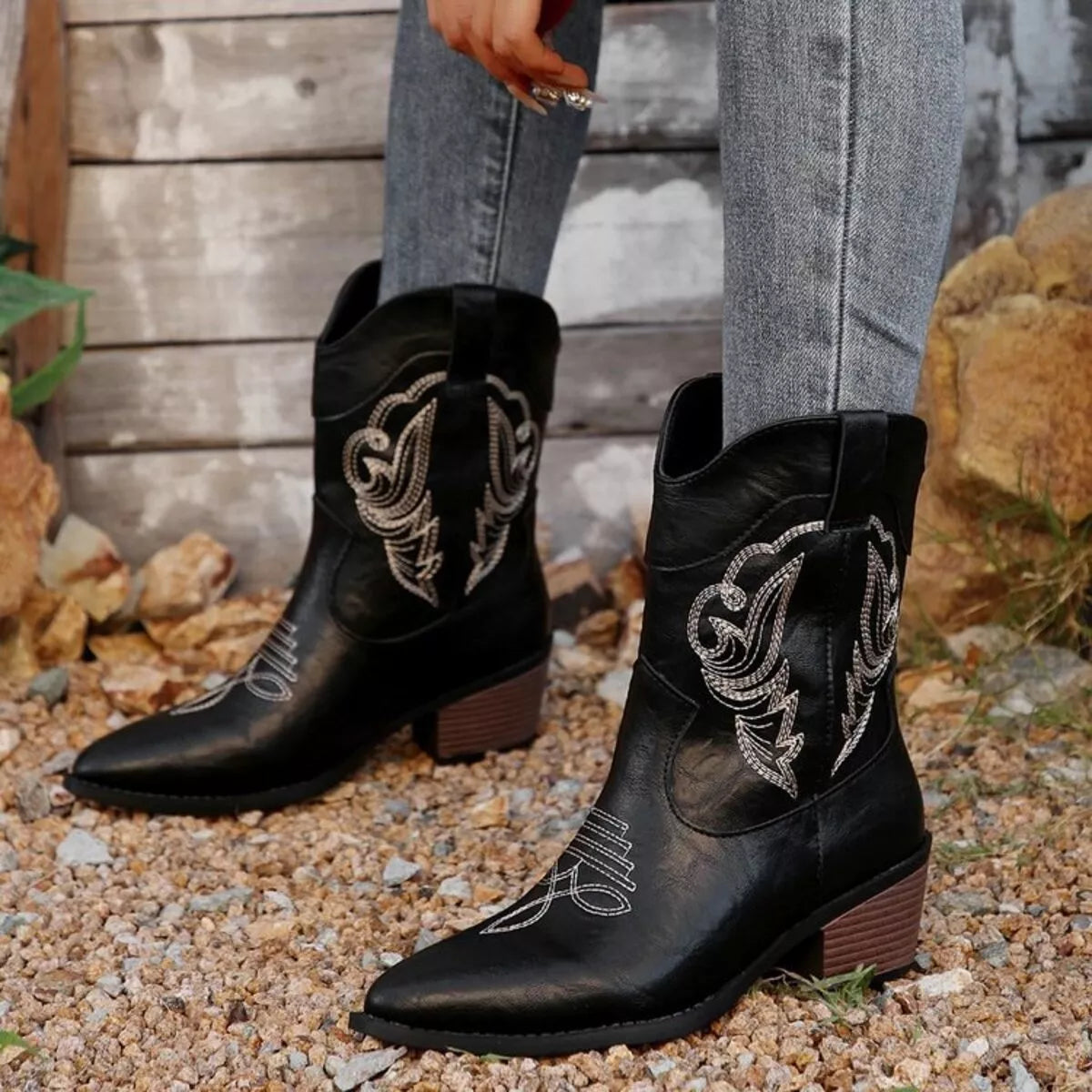Women's black Western cowboy boots with classic embroidered detailing and comfortable mid heel.