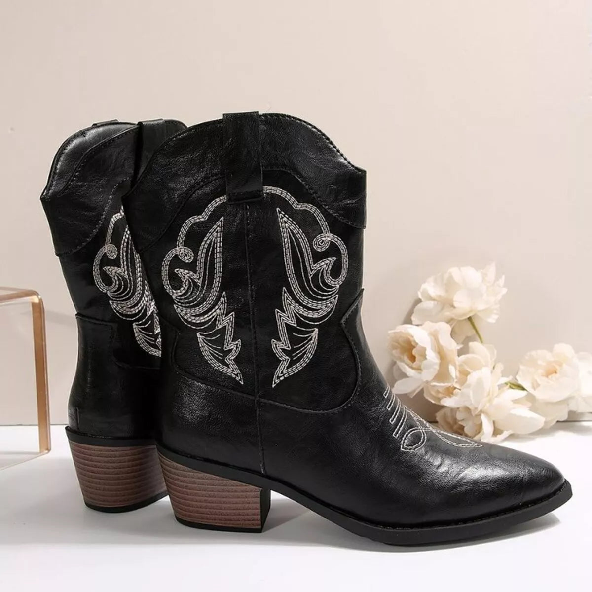 Women's black Western cowboy boots with classic embroidered detailing and comfortable mid heel.