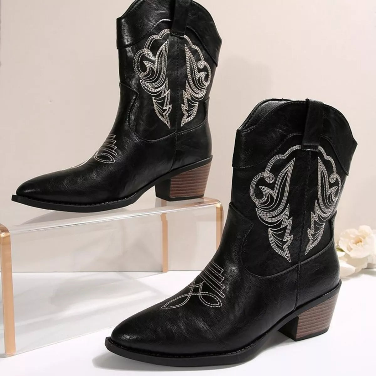 Women's black Western cowboy boots with classic embroidered detailing and comfortable mid heel.