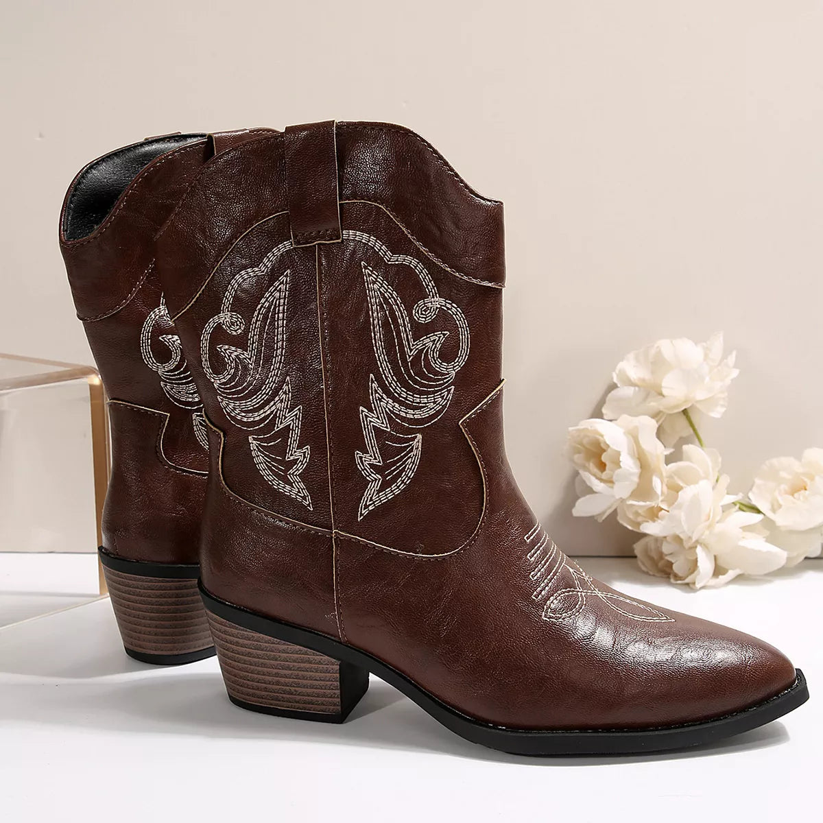 Women's brown Western cowboy boots with classic embroidered detailing and comfortable mid heel.