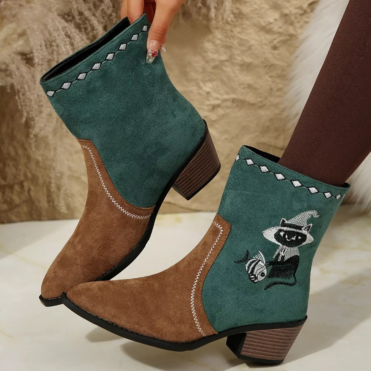 Women's green Western cowboy boots with classic embroidered detailing and comfortable mid heel.