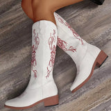 Women’s white Western cowboy boots with red embroidered detailing and mid-height block heels.