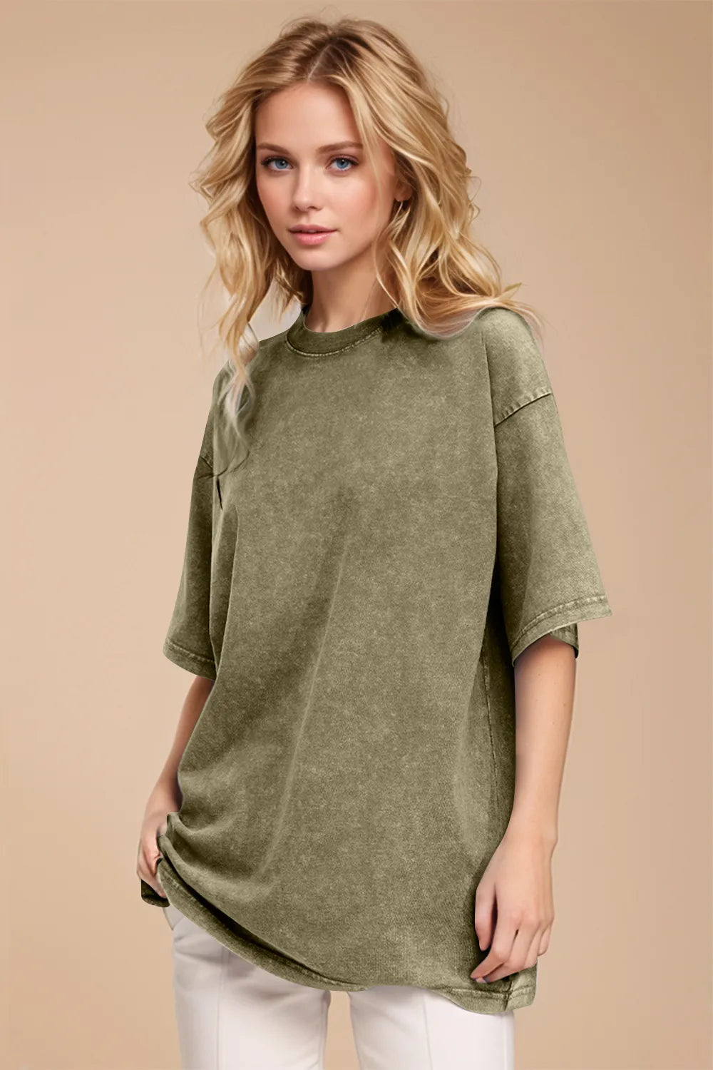 Woman wearing an oversized yellow-green Basic Bae round-neck half-sleeve T-shirt styled with dark denim jeans and a long pendant necklace for a relaxed, casual look.