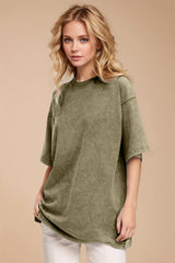 Woman wearing an oversized yellow-green Basic Bae round-neck half-sleeve T-shirt styled with dark denim jeans and a long pendant necklace for a relaxed, casual look.