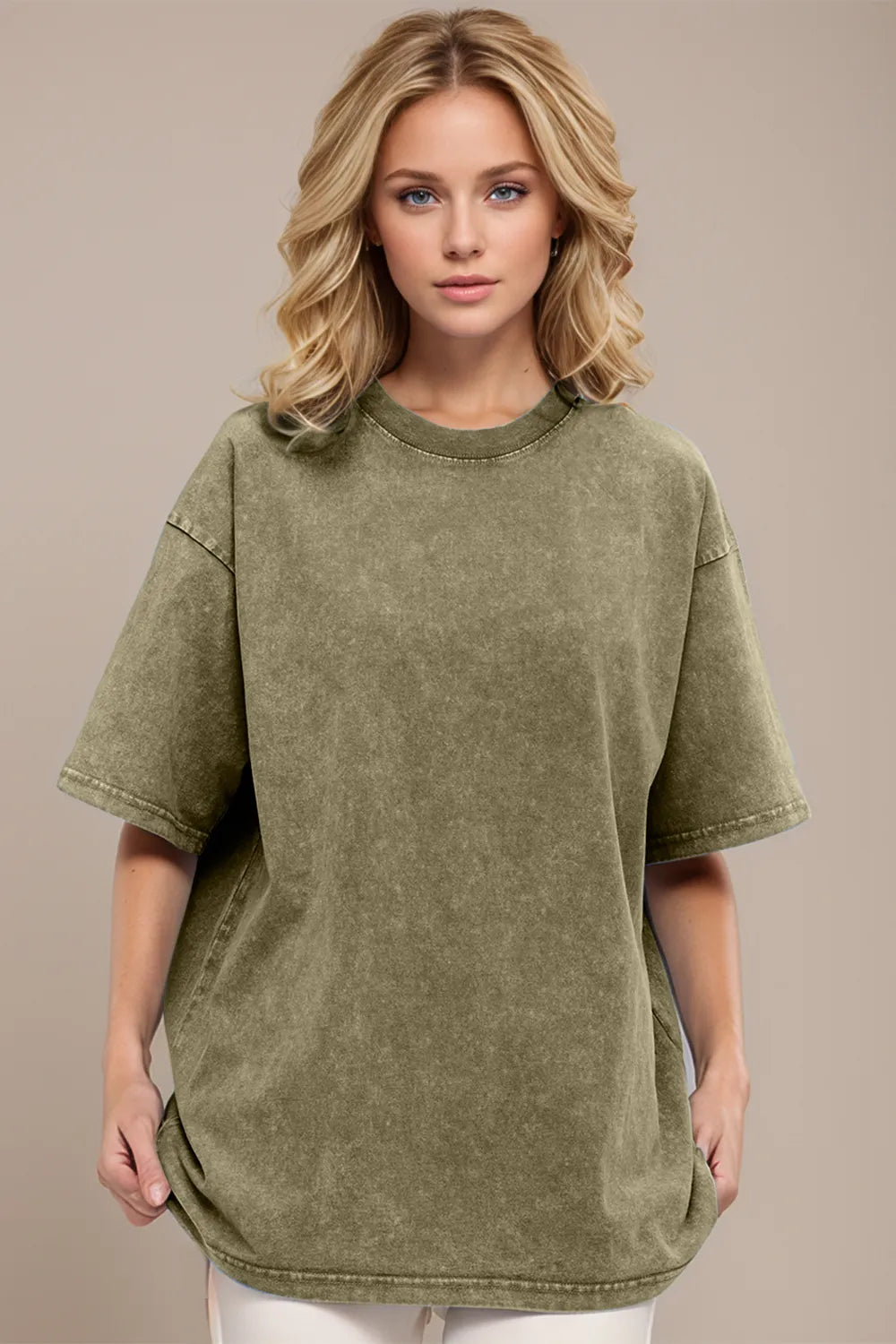 Woman wearing an oversized yellow-green Basic Bae round-neck half-sleeve T-shirt styled with dark denim jeans and a long pendant necklace for a relaxed, casual look.