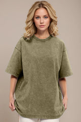 Woman wearing an oversized yellow-green Basic Bae round-neck half-sleeve T-shirt styled with dark denim jeans and a long pendant necklace for a relaxed, casual look.